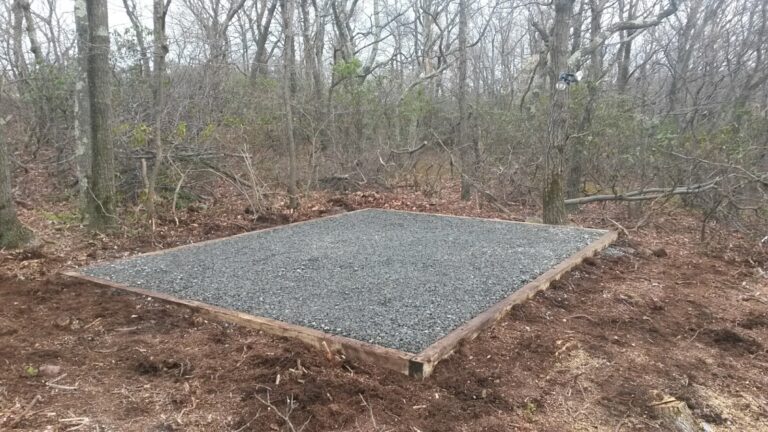 Gravel shed foundation installed in woods