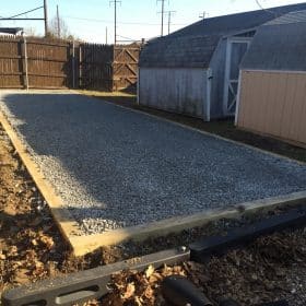 Stone foundation installed for a prefab shed