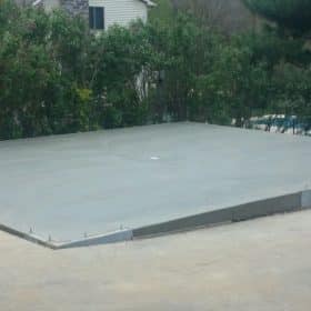 A concrete garage foundation built on a slope