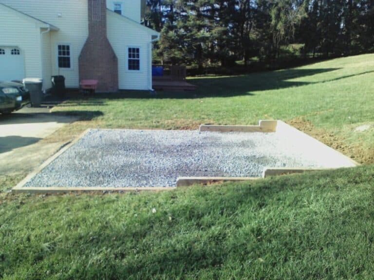 Gravel shed foundation installed in a sloped yard