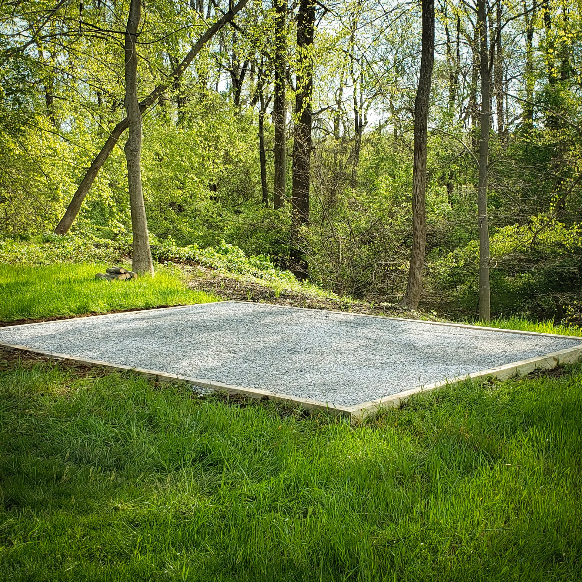 photo of a beautiful gravel foundation near the woods and surrounded by grass for a get a free quote on a gravel foundation page