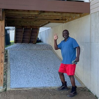 happy customer by deck with gravel under deck
