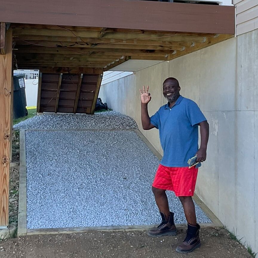happy customer by deck with gravel under deck