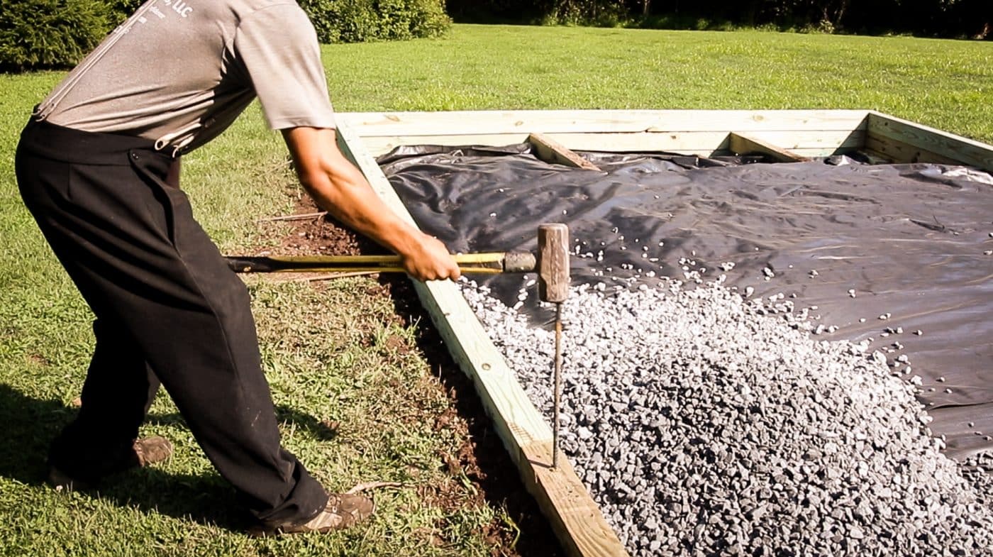 hammering-rebar-into-above-ground-pool-foundation-perimeter
