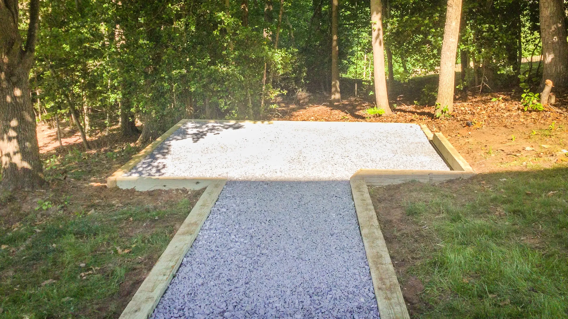 Site Preparation A gravel patio area with a gravel walkway