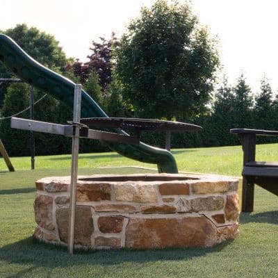 fire pit by artificial grass installation