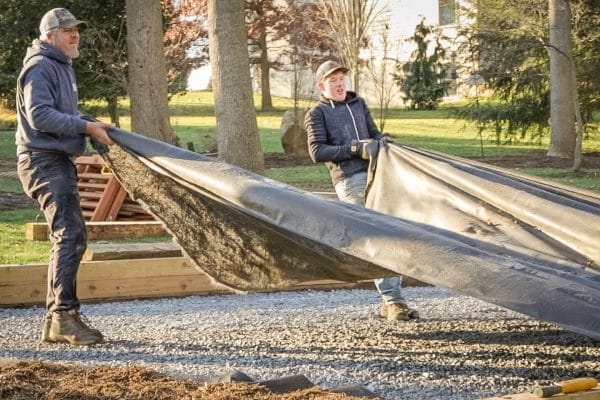 Adding weed barrier to a swingset base or playset foundation