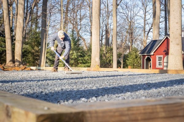 Spreading crushed stone for a swingset base or playset foundation