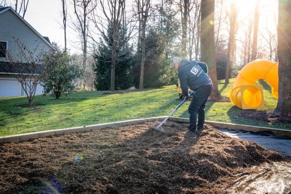 Adding wood chips to a swingset base or playset foundation