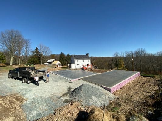 Contractors finishing a concrete foundation fo a garage in PA